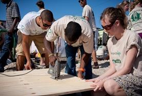 Building Building volunteers work together to construct a community centre in a local township in South Africa.