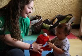 Care A volunteer plays with a child using a soft toy at our Care placement in Costa Rica.