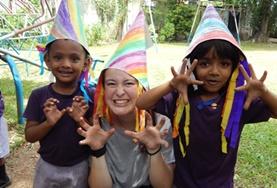 Care A childcare volunteer in Sri Lanka runs a creative arts and crafts lesson, teaching children to make colourful hats.