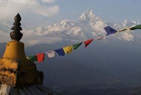 Conservation & Environment Tibetan flags with the Himalayas in the background at our Conservation pleacement in Nepal.