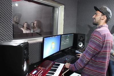 Recording vocals in the studio A volunteer records vocals during a music production internship at his placement in Cape Town, South Africa