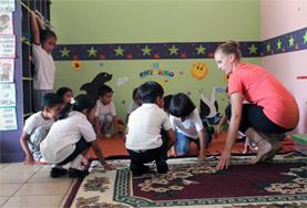 Ecuador A Creative Arts volunteer working in Ecuador teaches a music lesson to local students.