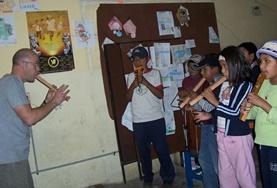 Bolivia A Music volunteer teaches a local child how to play wind instruments during a music therapy session in Bolivia.