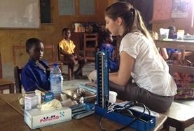 Ghana A volunteer in Ghana takes basic measurements to check the general health of a child during a Public Health screening outreach.