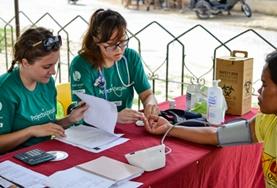 Philippines Public Health volunteers takes measurements like blood pressure and blood sugar levels during a medical outreach in the Philippines.