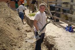 South Africa A High School Project Building volunteer assists with laying the foundation for a new house in South Africa.