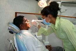 Medicine & Healthcare A high school student interning in Sri Lanka observes the work of a local dentist.
