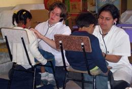 Medicine & Healthcare Two high school students measure children's heart rates during a volunteer Medicine outreach in Bolivia.