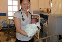 Jamaica A high school Public Health volunteer holds a baby in the maternity department of a hospital in Jamaica.
