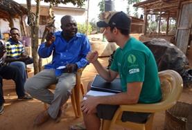 International Development An International Development volunteer discusses sustainable business plans with the staff member of a local NGO in Togo.