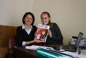 Journalism A local journalist and a Journalism intern in Romania hold the magazine they have been working on together.
