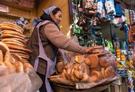 Language Courses Volunteers practise their Spanish language skills at a local market in Bolivia, South America.