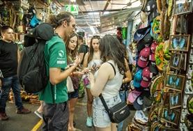 Language Courses Volunteers practise their Spanish language skills while speaking to local vendors at a market in Costa Rica.