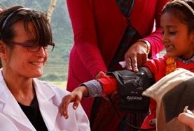 Nepal A Medicine volunteer measures a child's blood pressure during a healthcare outreach in Nepal.