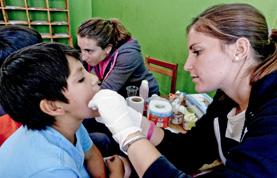 Medicine & Healthcare A Medicine intern examines a child during a medical outreach in Cusco, Peru.