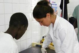 Senegal A Medicine intern in Senegal gains important work experience removing a bandage from a child's leg.
