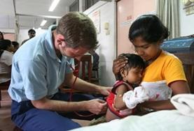 Medicine & Healthcare A Medicine volunteer performs a general check-up on a young child during a healthcare screening in Sri Lanka.