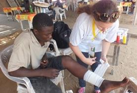 Medicine & Healthcare A Medicine volunteer assists with dressing a patient's wound during her internship in Togo.