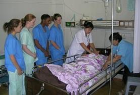 Medicine & Healthcare Nursing interns in Mongolia observe as local doctors insert an IV into a patient as part of her treatment.
