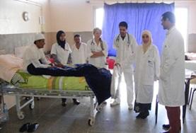 Medicine & Healthcare Nursing volunteers doing internships in Morocco observe as a local doctor speaks to a patient about his symptoms.