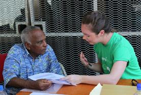 Fiji A Nutrition intern measures a man's blood sugar level during a diabetes awareness campaign at our volunteer placement in Fiji.
