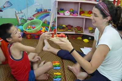 Occupational therapy volunteer Occupational Therapy volunteer Jillian Meyers (USA) working with physically disabled child at Thuy An Rehabilitation Center