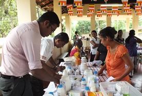 Medicine & Healthcare A Pharmacy intern shadows a local pharmacist as he dispenses medicine to local people in Sri Lanka.