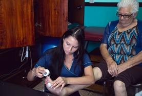 Medicine & Healthcare A Physiotherapy intern works with an elderly patient in Costa Rica, stretching her muscles and helping to strengthen her legs.
