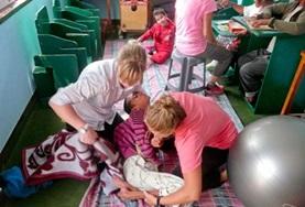 Medicine & Healthcare Two Physiotherapy volunteers work together to treat a disabled child during their internship in Nepal.