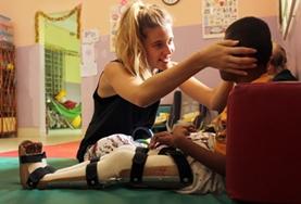 Medicine & Healthcare A Physiotherapy intern at our volunteer placement in the Philippines works with a disabled boy on improving his mobility.