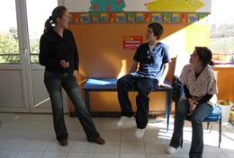 Medicine & Healthcare Physiotherapy interns volunteering in Romania listen as a local physiotherapist teaches them about therapy techniques.