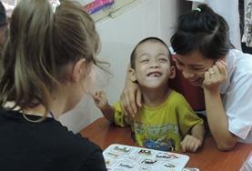 Medicine & Healthcare A Speech Therapy volunteer works on a language task with a disabled boy at our internship in Vietnam.