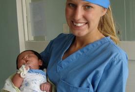Midwifery A Midwifery intern holds a newborn baby in the maternity department of a hospital in a developing country.