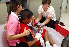 Occupational Therapy An Occupational Therapy volunteer works closely with a local child to improve his daily functioning during her medical internship.
