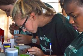 Pharmacy Pharmacy interns sort through medication and help with distributing it to members of a local community during a volunteer outreach.