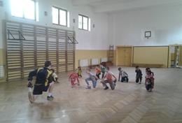 Sports A Soccer volunteer leads a sports team in Romania through a stretching routine before they start their practice.