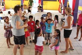 Sports School Sports volunteers play a ball game with young children in Belize to promote physical development and fitness.