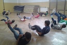 Sports A School Sports volunteer leads a stretching class during a physical education lesson with school children in Romania.