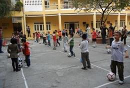 Sports A Sports volunteer coaches a team of school students during a soccer lesson in Vietnam.