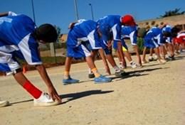Sports Young athletes stretch before a race on a running track at our volunteer Athletics placement in Sri Lanka.