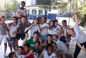 Multi-sports A local sports team poses together with the volunteer who has been coaching them at one of our Multi-sports placements.