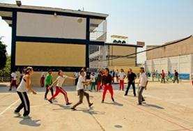 Volleyball Volunteers and school children practise their volleyball skills during a sports practice.