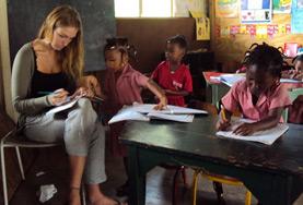 Jamaica A volunteer works closely with local school children during an English language lesson on our Teaching project in Jamaica.