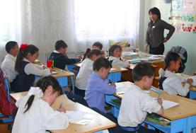 Mongolia A volunteer works through an English language exercise with school students at our Teaching placement in Mongolia.
