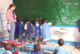 Senegal School children in Senegal work together to solve a problem on the blackboard at our volunteer Teaching placement in Senegal.